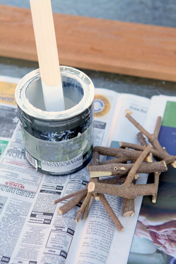 This inexpensive and easy weekend project shows you how to create a stylish branch coat rack with just some branches, paint, and a few tools.