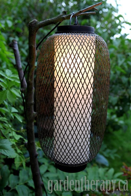 Outdoor lamp using a tree branch as the pole