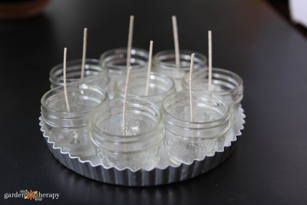 jars with wicks added for making candle wedding favors