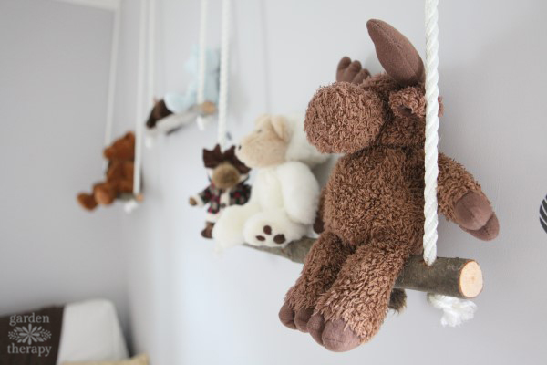 branch swing shelves in a nursery with stuffed animals