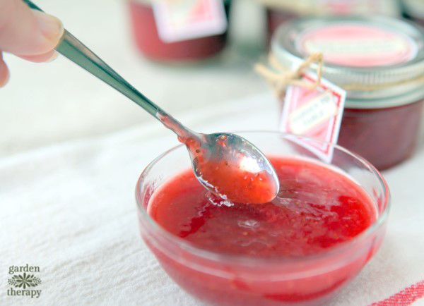 Low Sugar Strawberry Freezer Jam being scooped with a spoon.