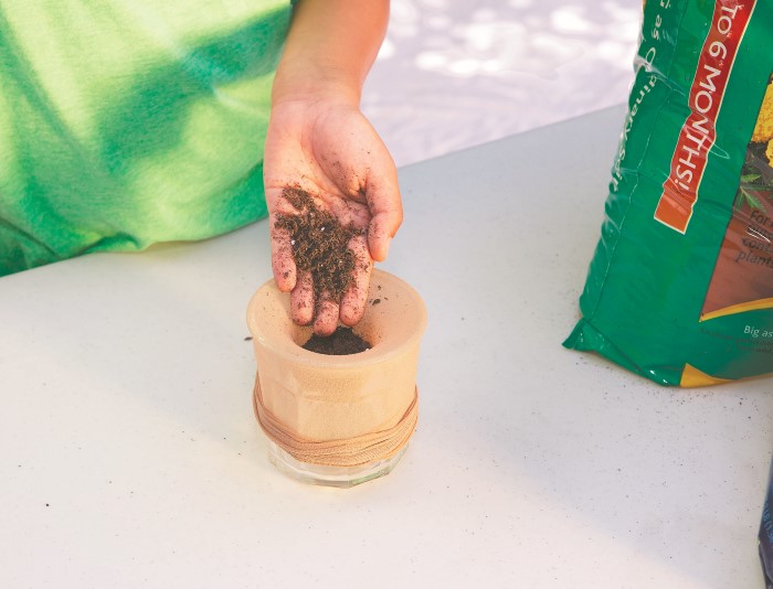 Step 2 of making grassy garden gnomes with kids