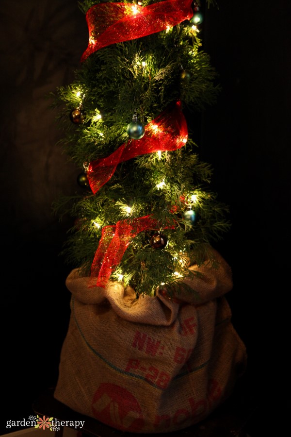 Grinch tree in a burlap sack with red mesh