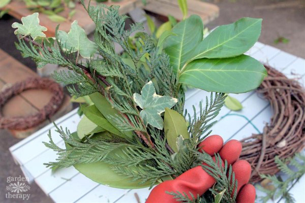 Bundling fresh evergreens to make a wreath