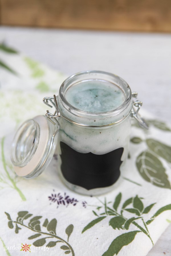 Mint sugar scrub in a glass jar with chalkboard label.