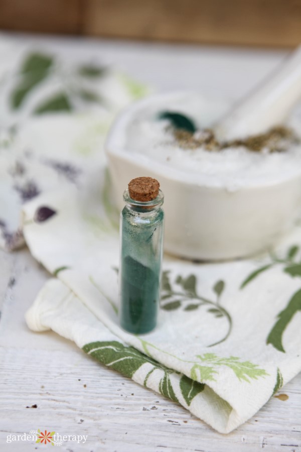 spirulina powder being added to peppermint sugar scrub to give it a green color