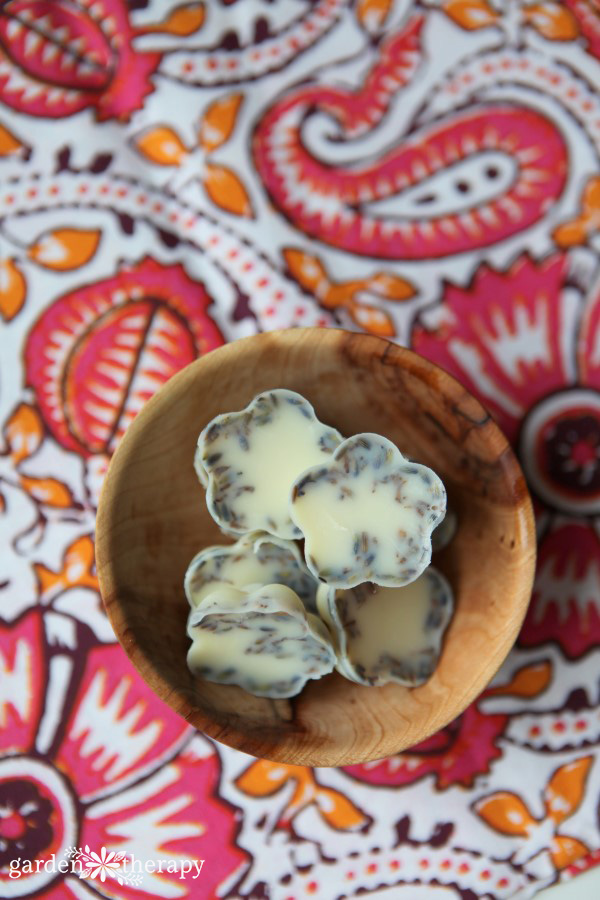bath melts made with cocoa butter and dried lavender in a wooden bowl