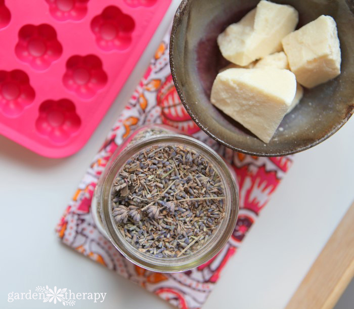 Ingredients for making bath melts - silicone mold, cocoa butter, and dried lavender