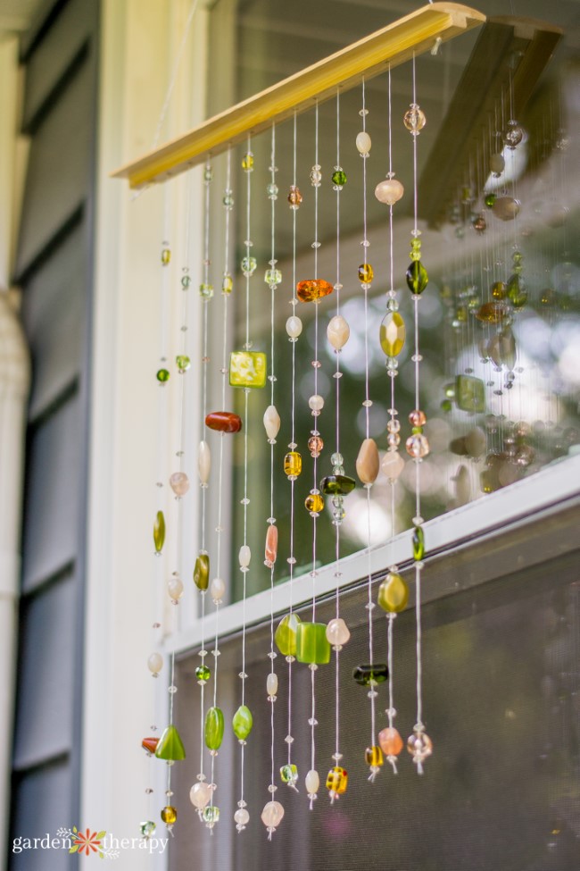 beaded suncatcher in front of a window to protect birds