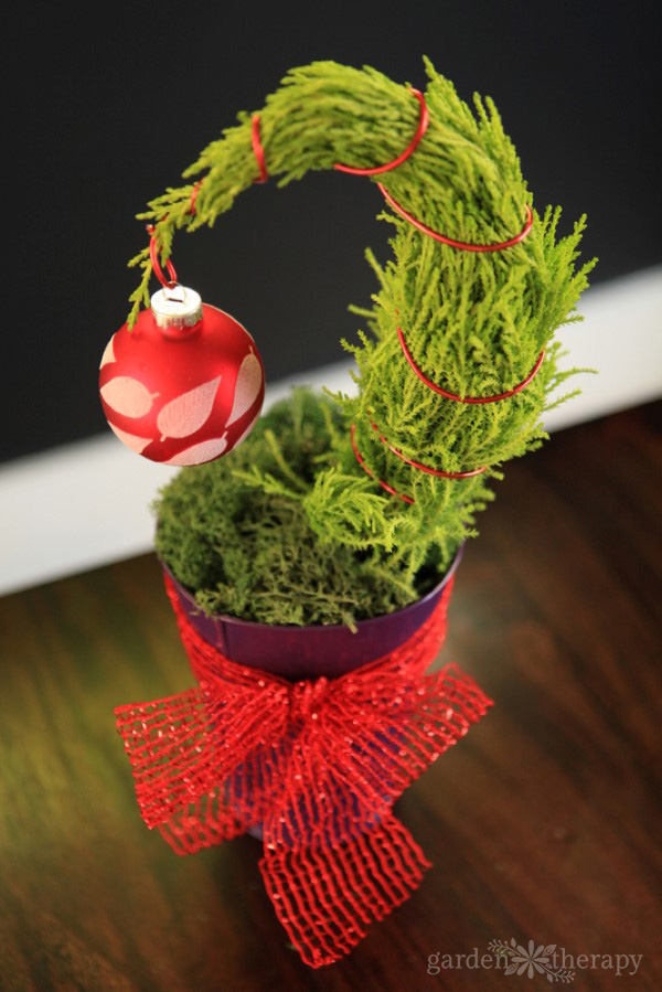 mini Grinch tree with a red ornament and bow