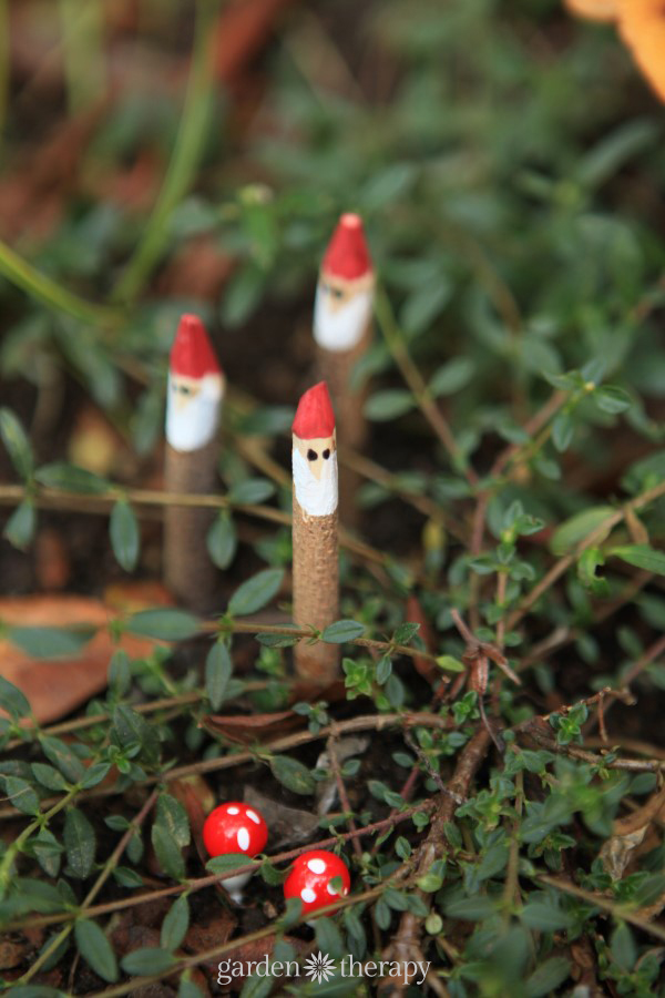 small painted twiggy gnomes in a garden