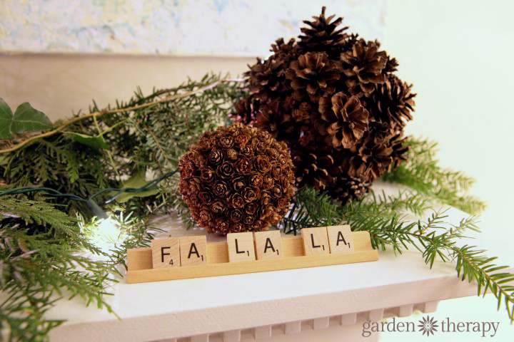 Christmas scrabble decor with pine cones and greenery