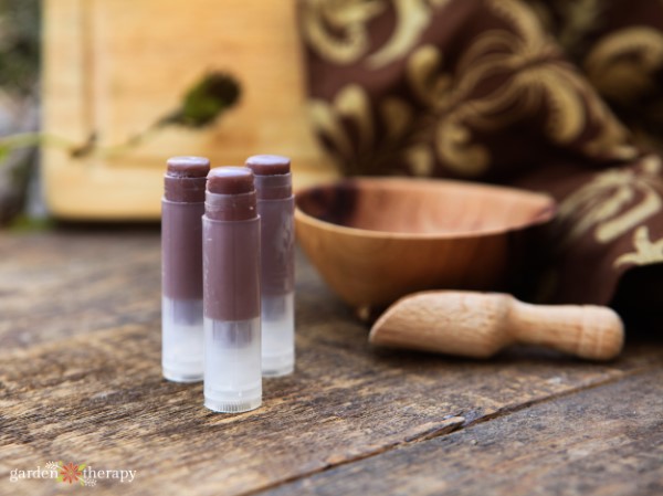 purple homemade Lip Balm on a vintage table with earthy decor