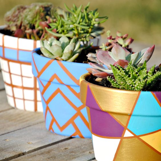 Painted geometric flower pots from 32 Terracotta Pot Hacks