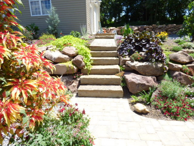 Steps leading up to the house through the rock wall gadren