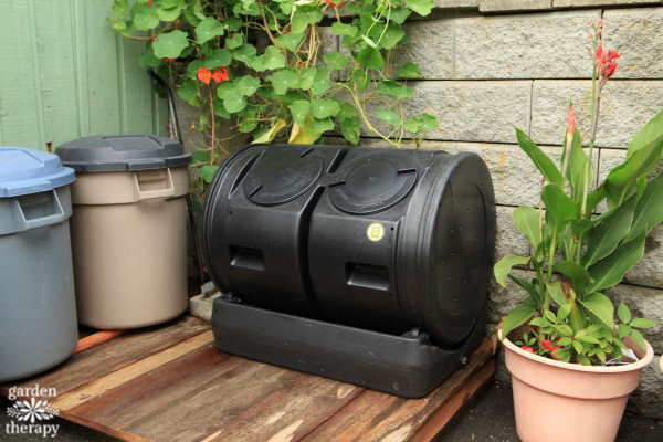 black compost tumbler on the back deck