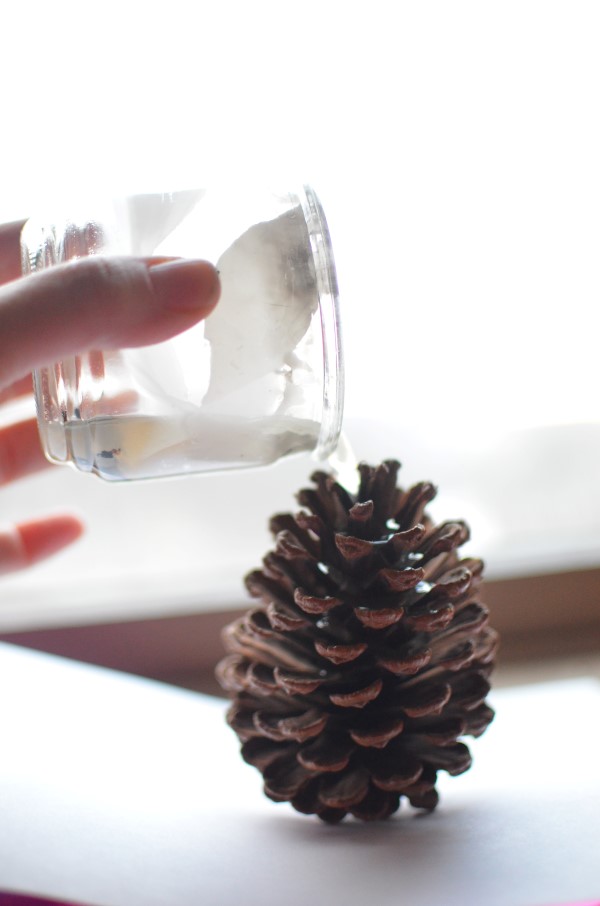 pouring wax to make a diy pinecone firestarter