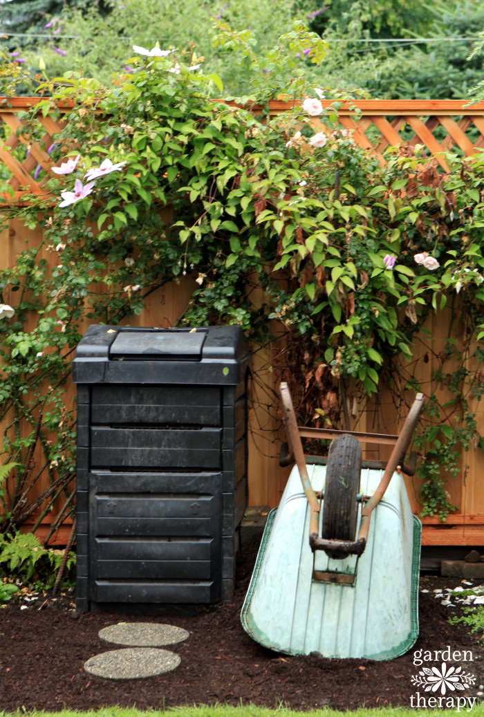 Compost bin along a fence