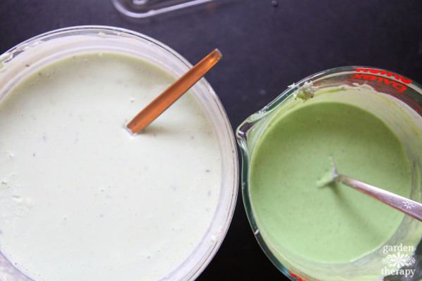 two containers of melted green and white soap