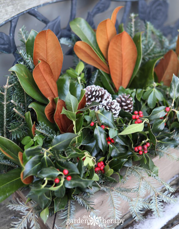 festive holiday window box with a wood planter and some fresh Christmas greenery
