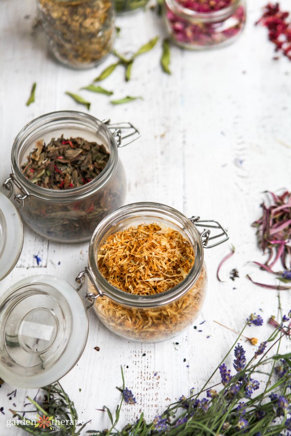 dried herbs and flowers for tea in glass jars