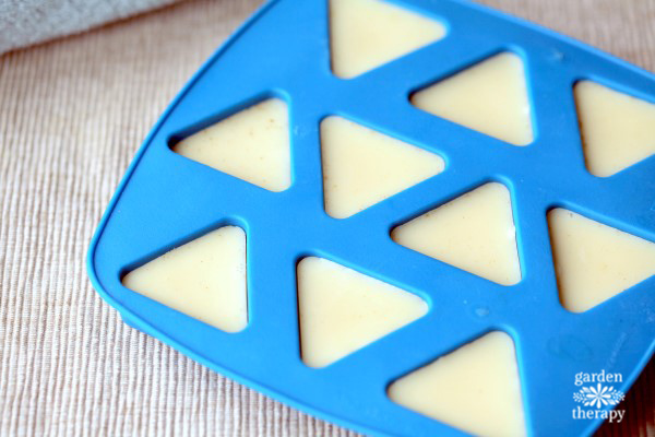 Blue ice tray triangular mold with white vanilla lotion hardening