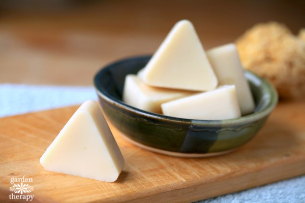 White triangle lotion bars on a wooden board