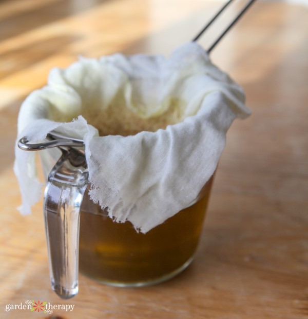 How to Make Herbal Oils straining out herbs