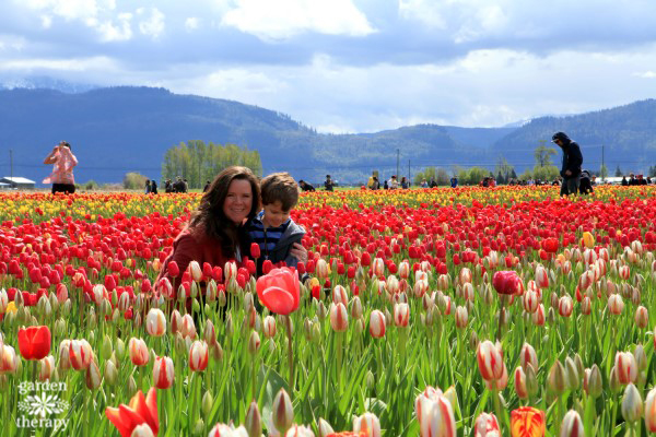 Stephanie and kiddo in field of tulips at tulip festival