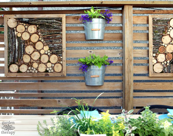 wooden fence art and pots hanging on wooden fence