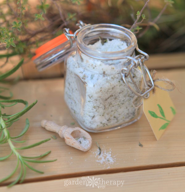 Fresh herb finishing salt in a jar with a small wooden spoon