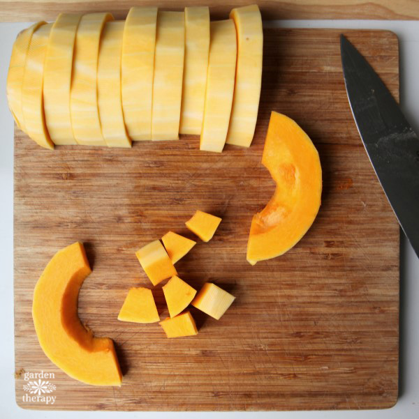 Slicing butternut squash to size before roasting it.