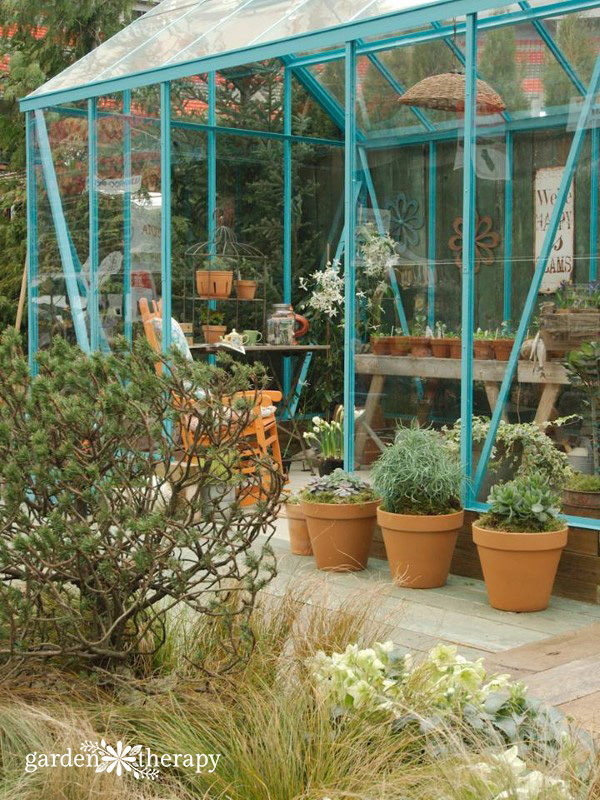 Outdoor greenhouse filled with plants to keep them safe from frost