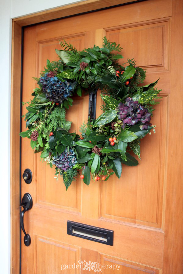 DIY Christmas wreath hanging on a light wood door