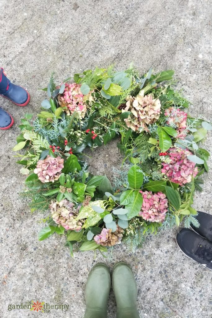 Large and full green wreath featuring dried pink hydrangea flowers