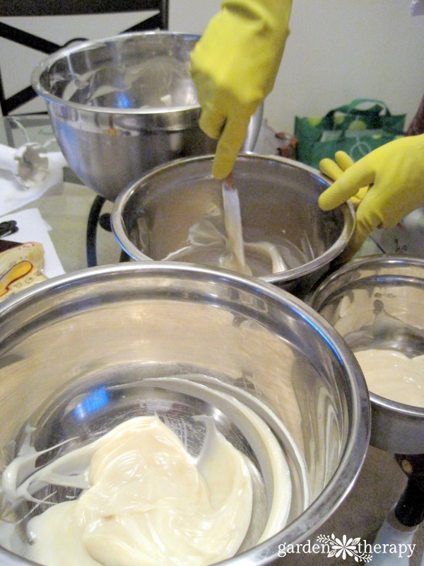 Stirring cold process soap ingredients together into a thick mixture