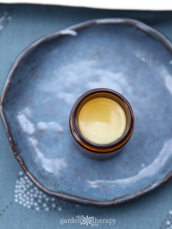 close up of healing salve in a small amber jar