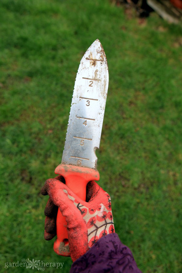 A soil knife with depth measurements along the blade