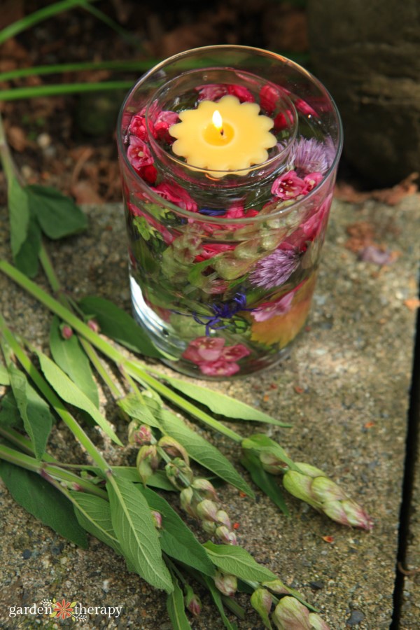 floating candles in a vase of flowers
