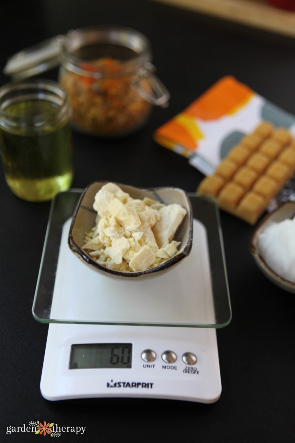 weighing ingredients for calendula summer lotion bars