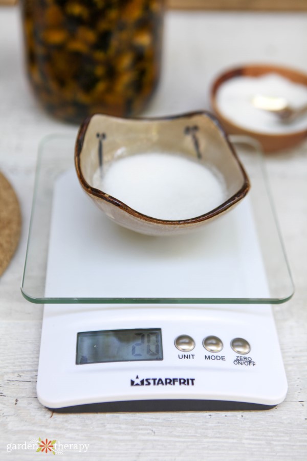 weighing sugar for an exfoliating lip scrub