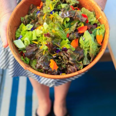 A salad topped with edible flowers
