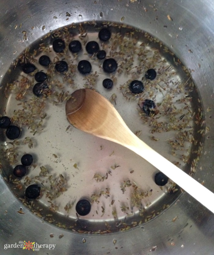 ingredients for lavender syrup being mixed together in a pot