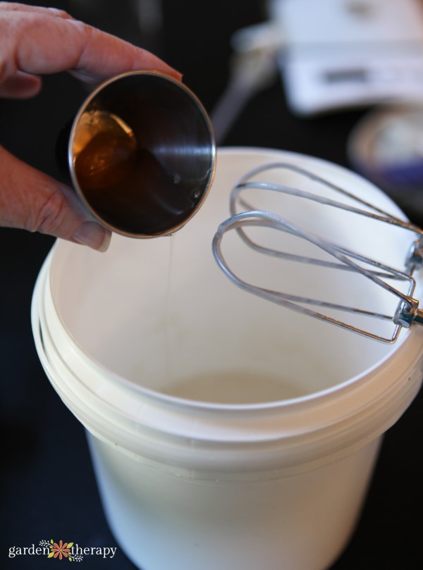 adding ingredients to a larger container for mixing