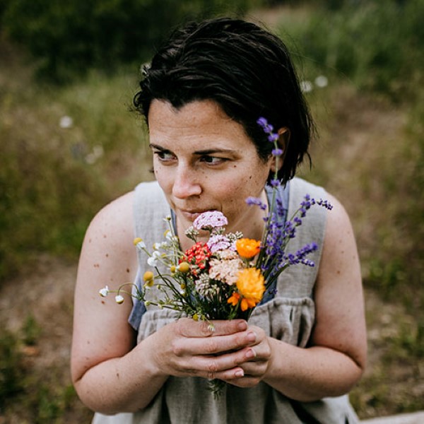 Colleen Codekas, author of Healing Herbal Infusions, holding a bunch of fresh flowers from her garden