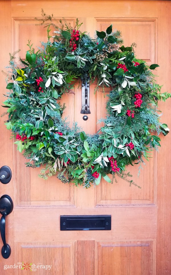 Fresh wreath on light wooden door