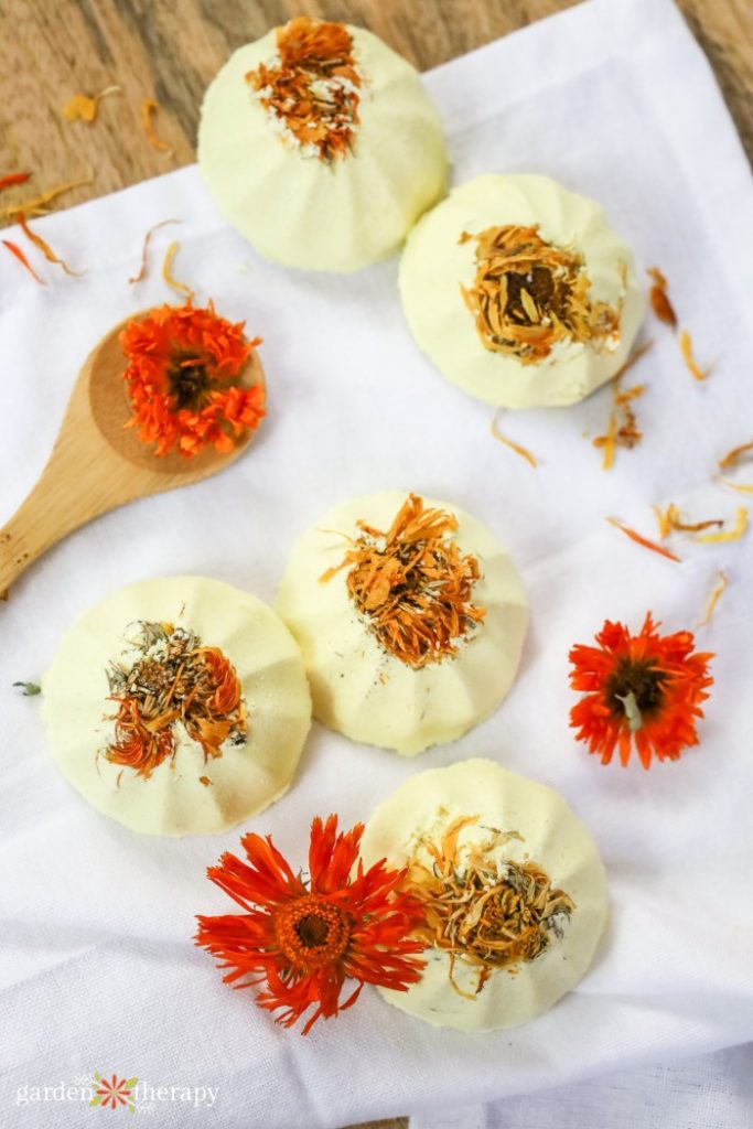 Shower steamers with dried flower petals on a white towel 