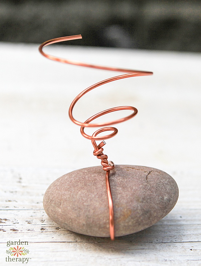 copper wire twisted around a rock stand