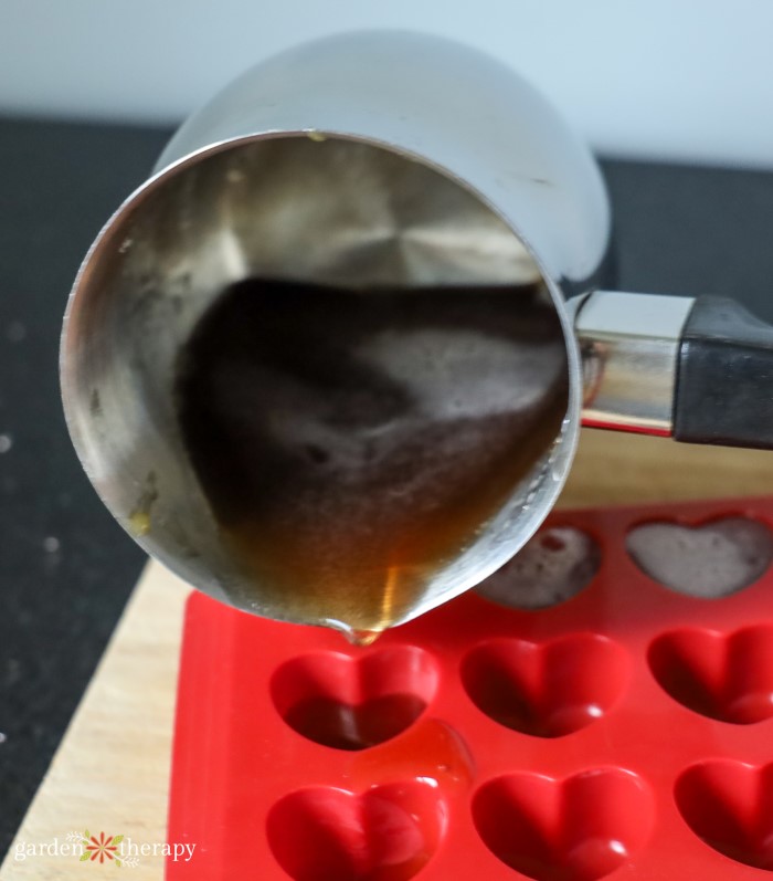 Pouring lozenges into a heart shaped mold