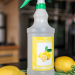 DIY granite cleaner with lemon and rosemary on a countertop